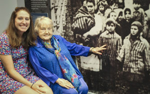 Casey Bush with Eva Kor, who points to a picture of her and her twin at Auschwitz