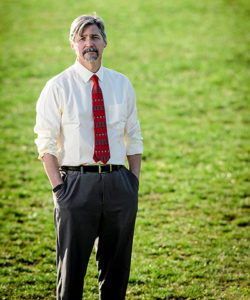 Paul Robbins standing on grass lawn