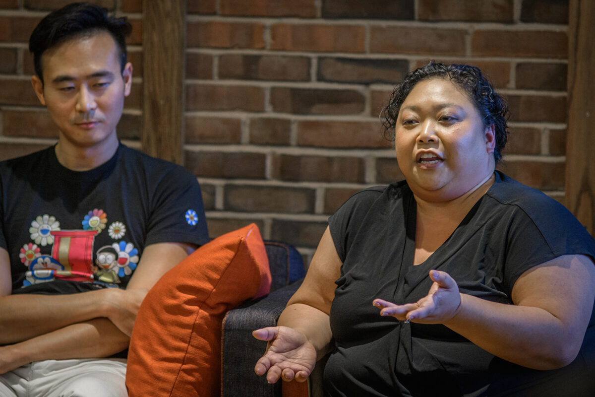 Professor Lex Jing Lu listens as Maria Gallant speaks at the recent panel discussion on the film "Crazy Rich Asians"