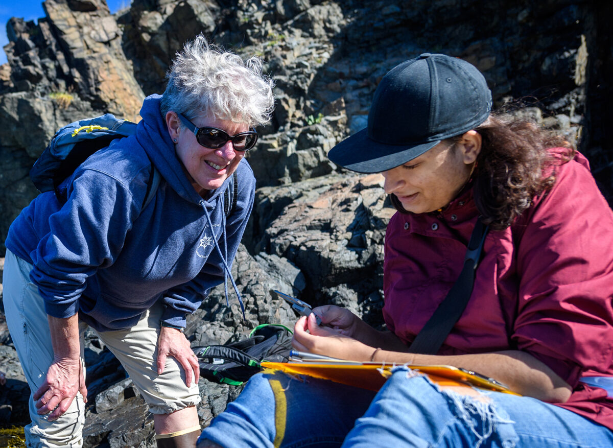 Professor Deb Robertson with a student near the ocean