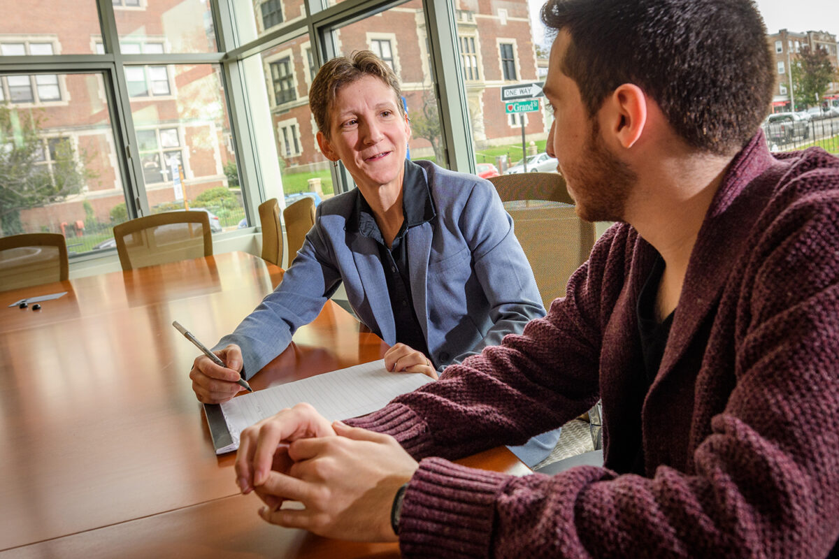 Jennifer Plante works with a Clark University student.