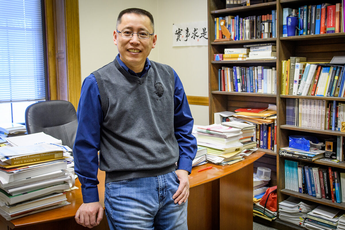 Junfu Zhang standing in his office