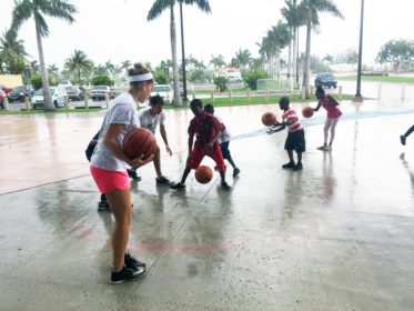 Maggie Tarbox plays basketball with children as part of Project Limestone in the Bahamas.