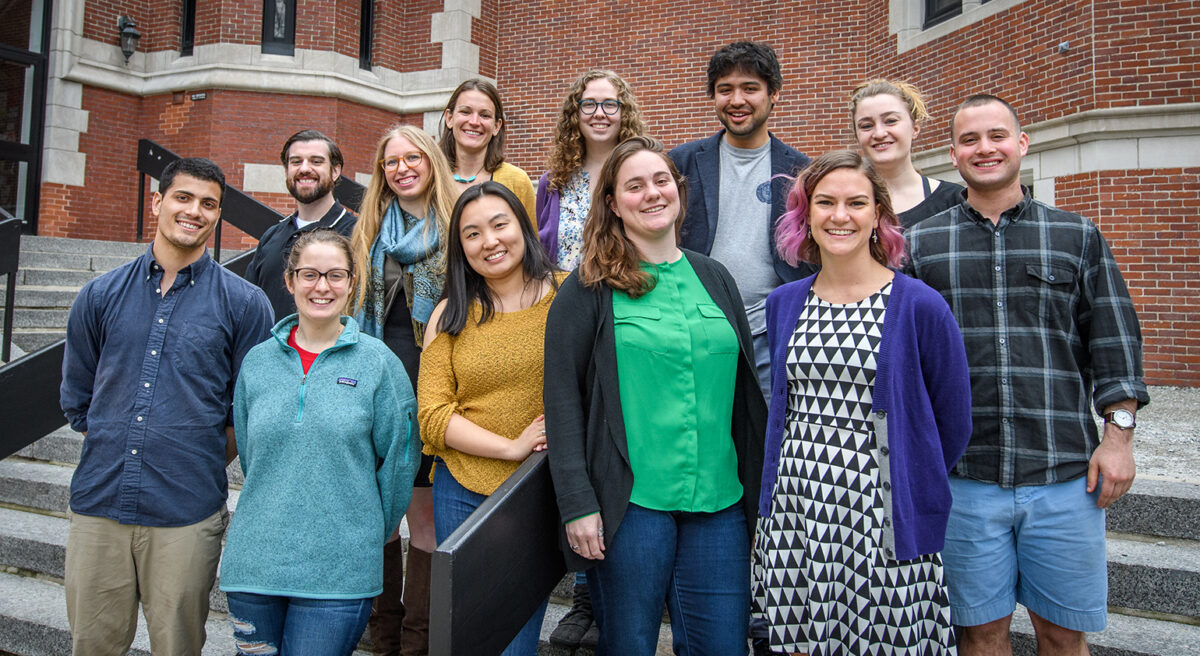 Students in GIS class stand outside on steps