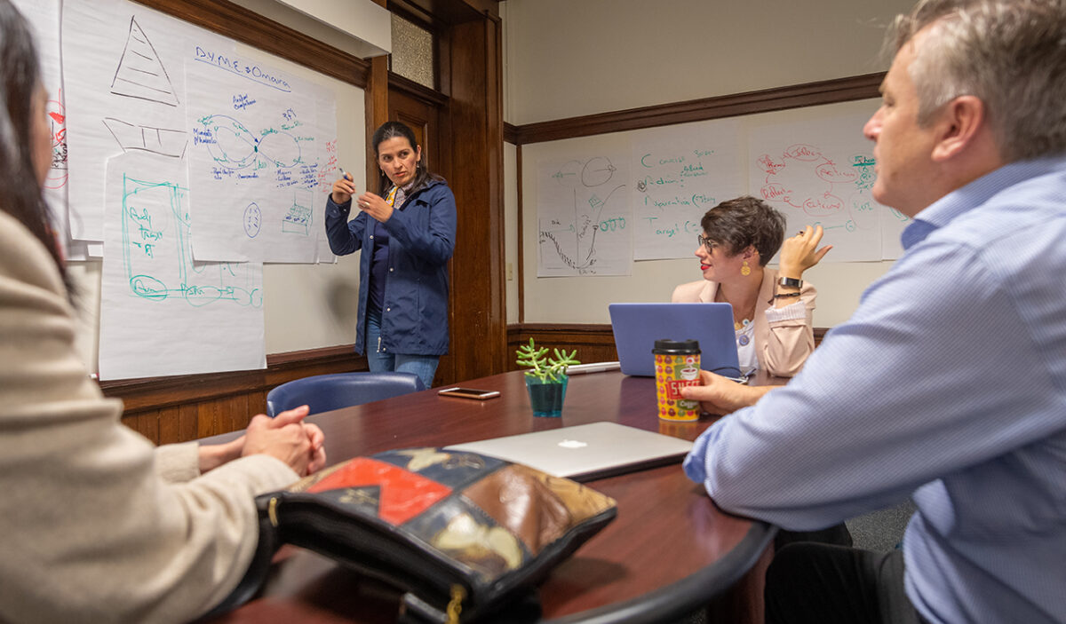 John Dobson works with students in his entrepreneurship workshop at Clark University