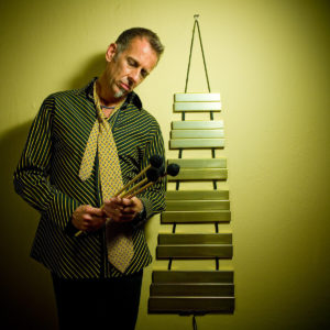 Joe Locke standing next to sculpture