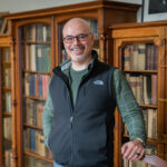 professor standing in library