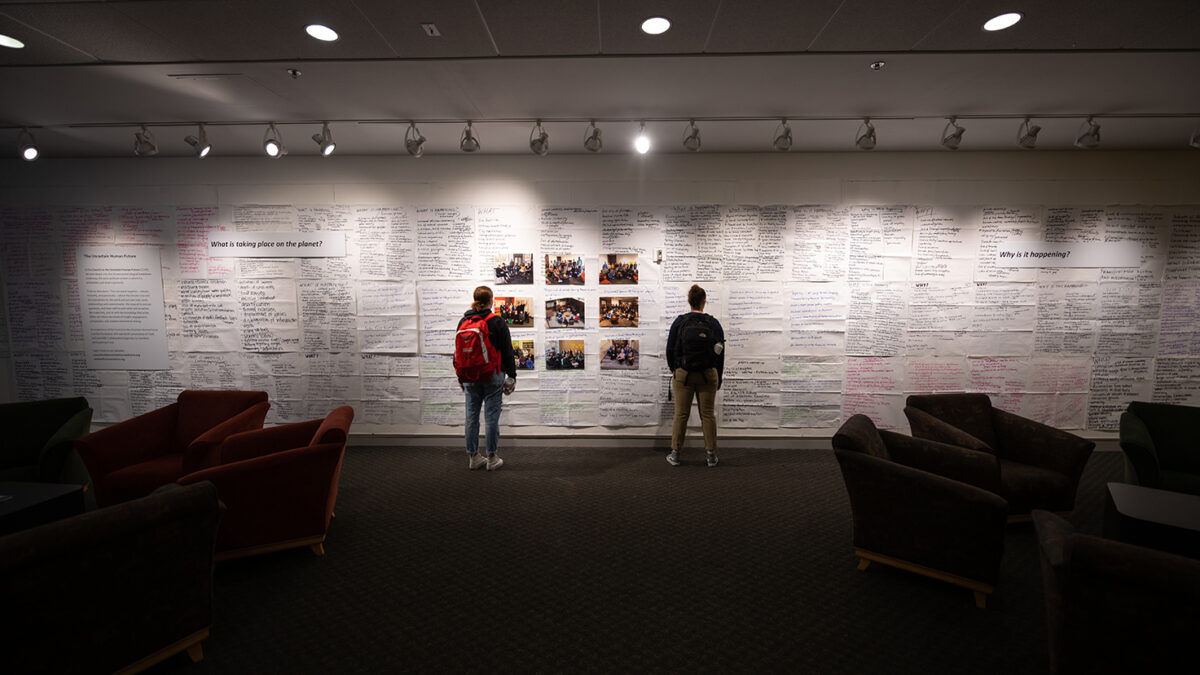 Students view the Council on the Uncertain Human Future exhibit at the Clark UniversityTraina Center