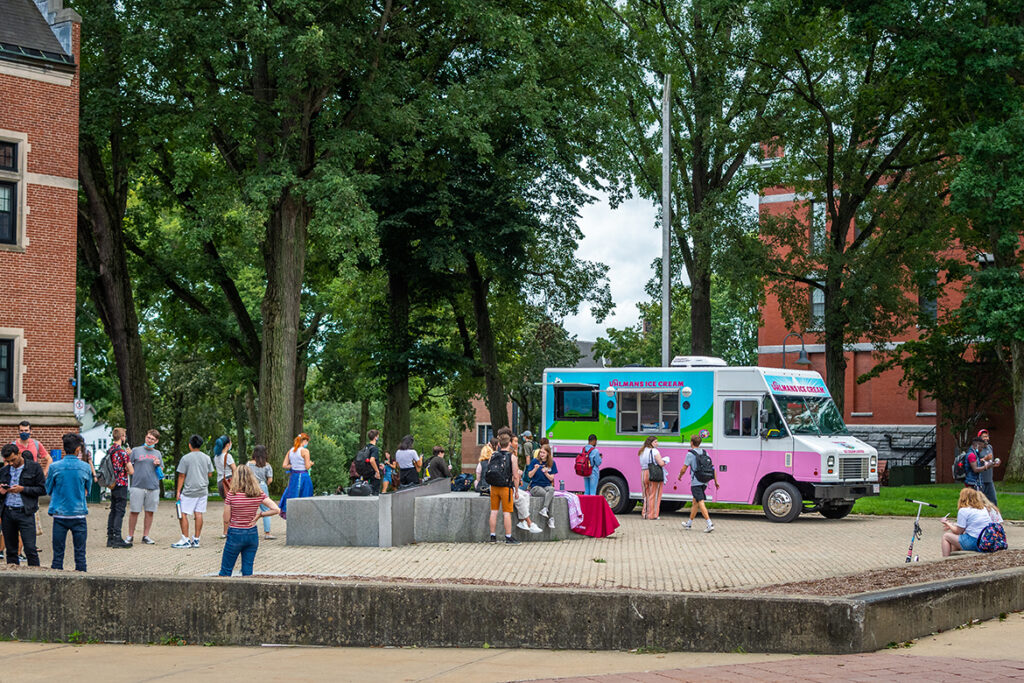 Students wait in line at an ice cream truck on campus
