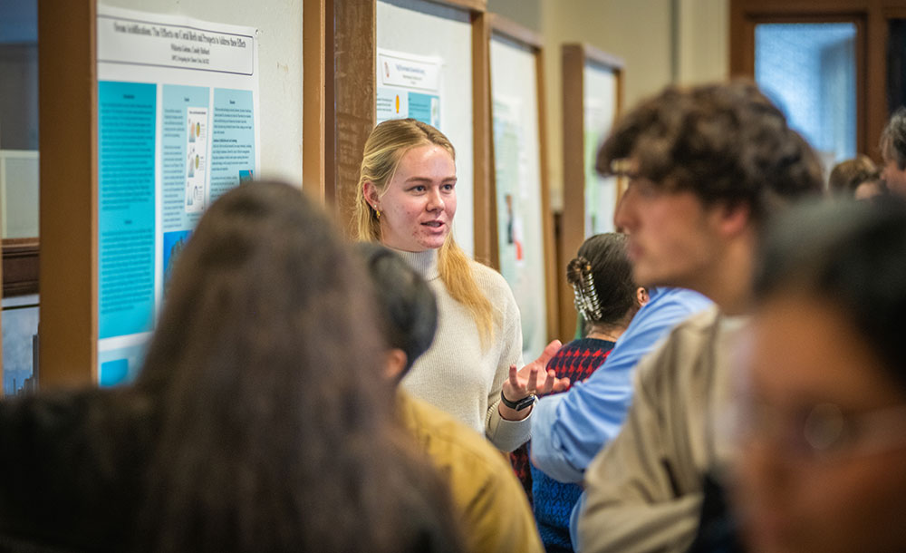 Student showing poster