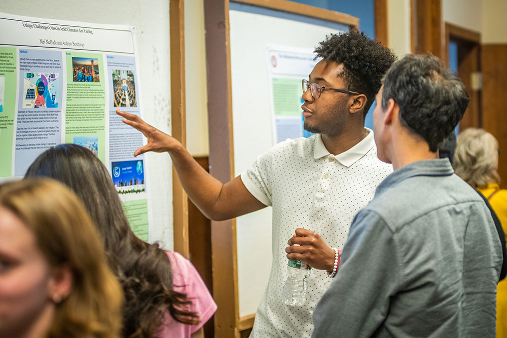 Student showing poster