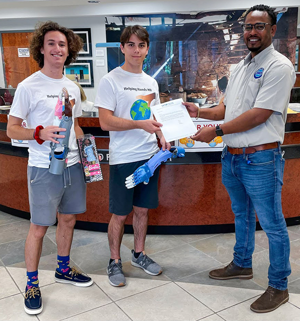 Jonathan Tamen and his brother, David, are honored for their work with Helping Hands MB. 
