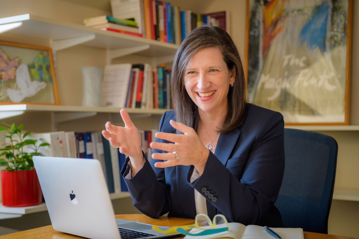 Margaret Post talking at her desk
