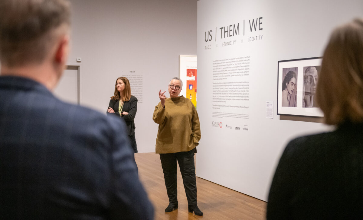artist addresses guests at museum
