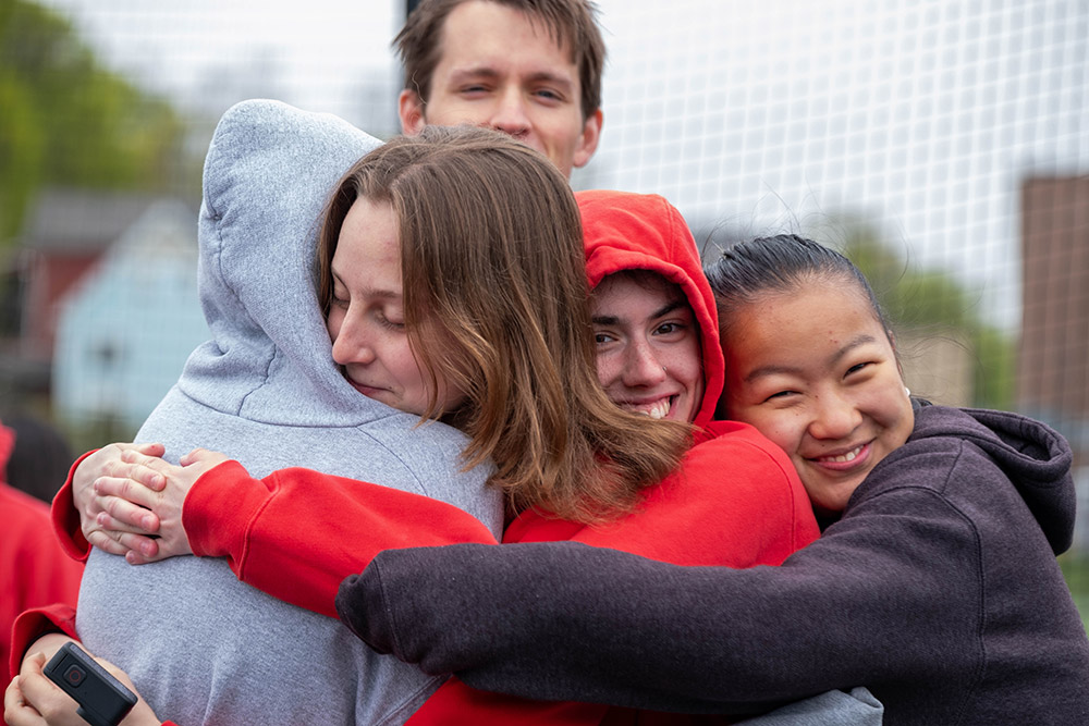 Students embracing after an Earth Day race event