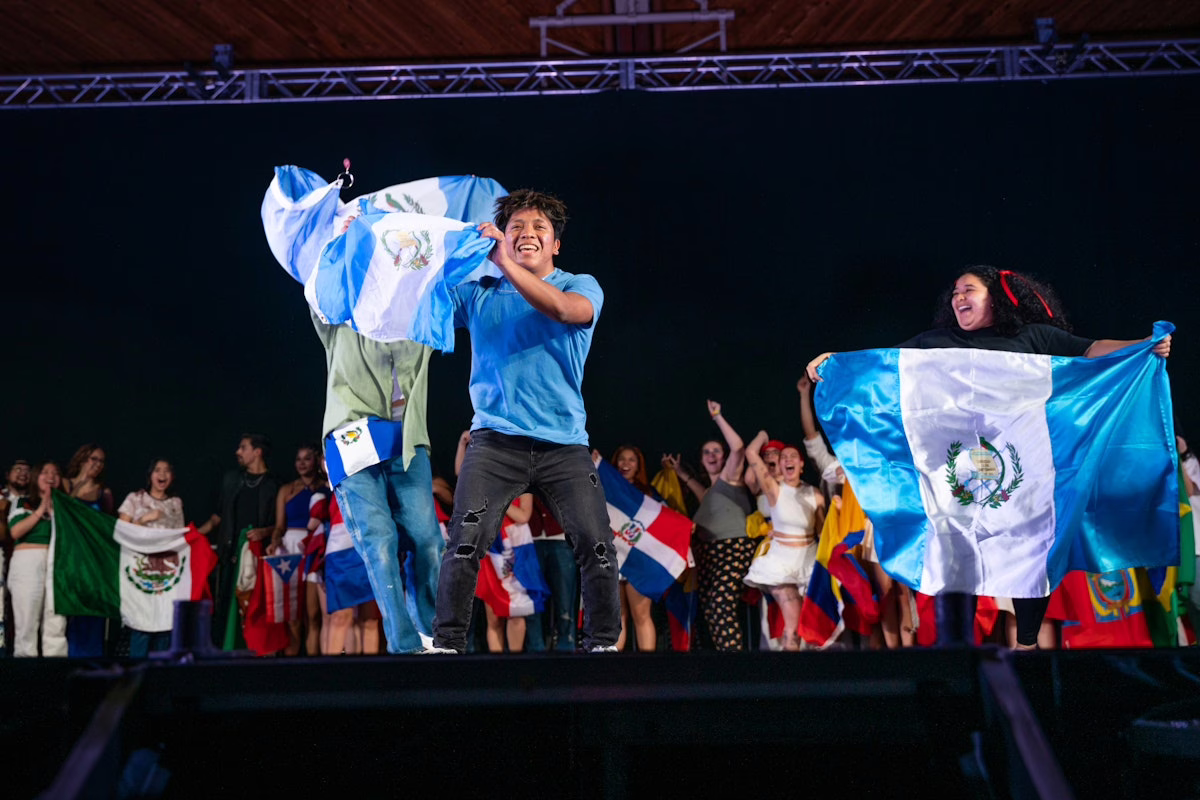 people on stage with flags