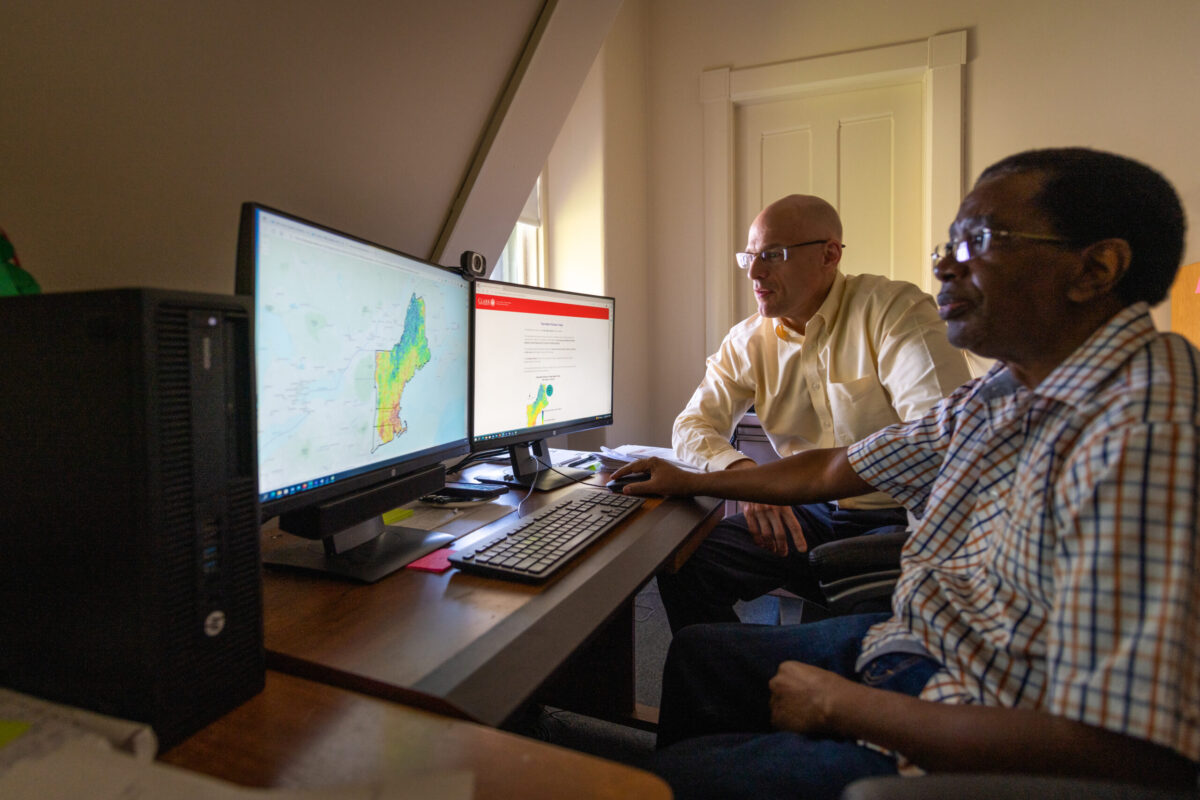 Two men sitting at computer