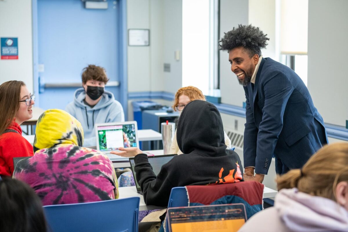 professor talks to students in classroom