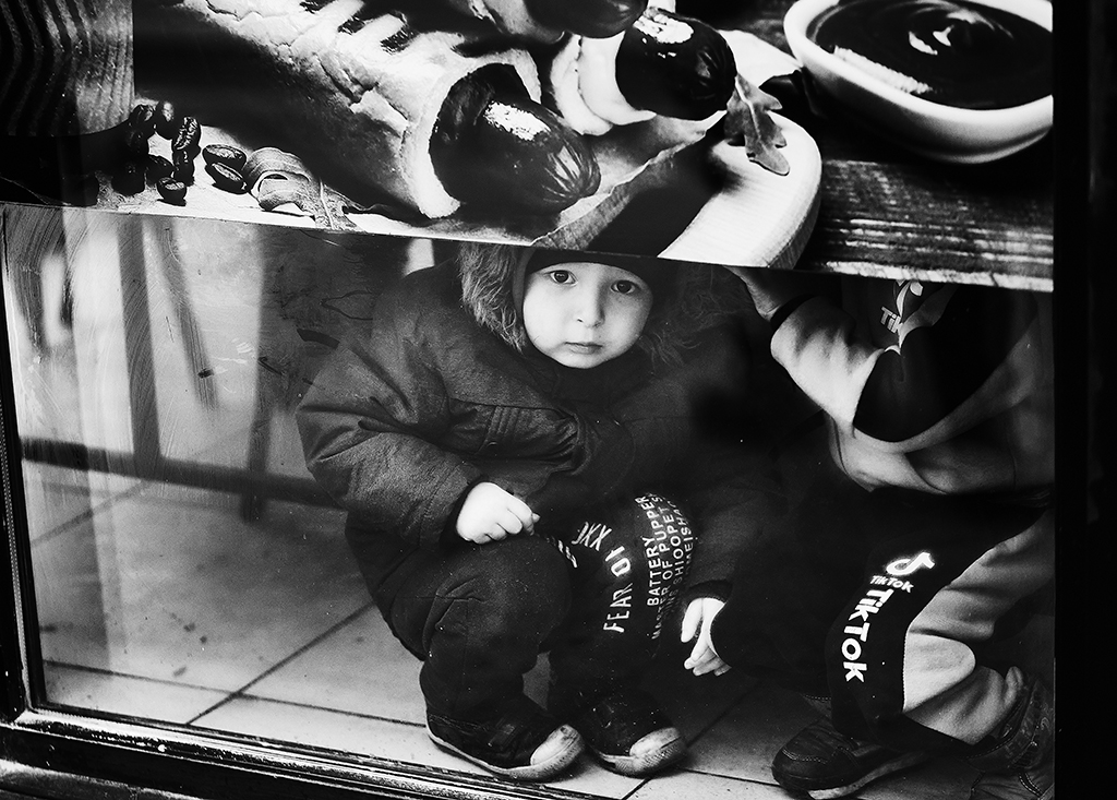 Child hides in air raid shelter in Ukraine