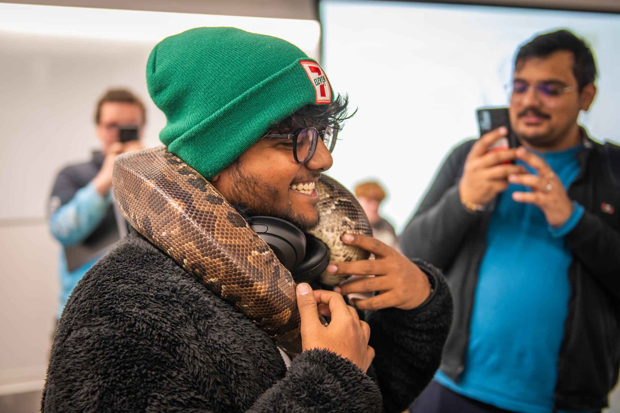 student with snake around neck