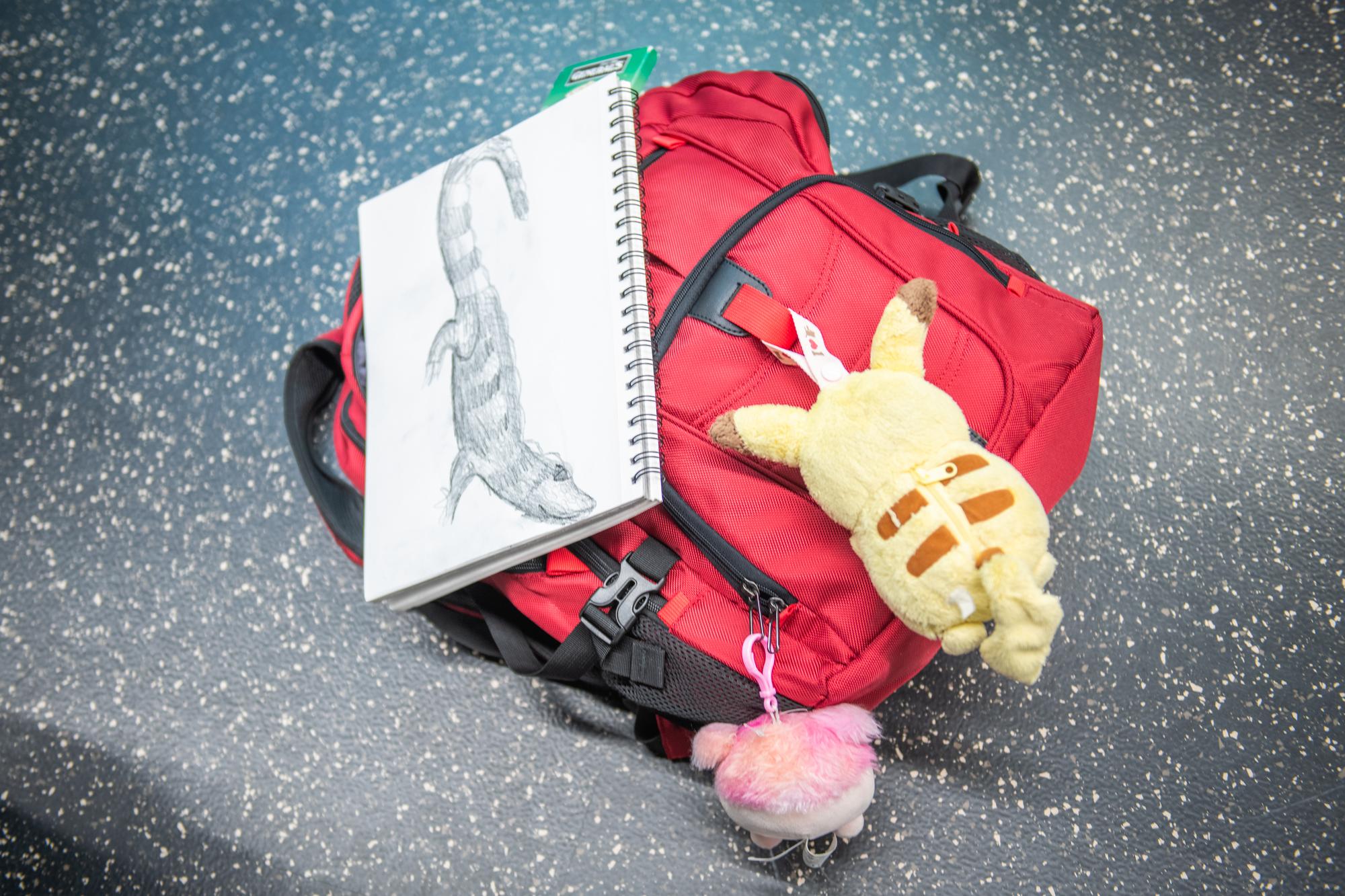 red backpack and sketch on notebook