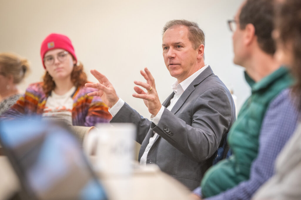 President David Fithian meets with students working on an environmental restoration initiative