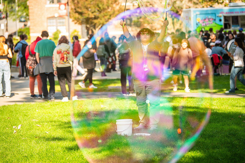 Student creating giant bubbles during the annual Fresh Check event