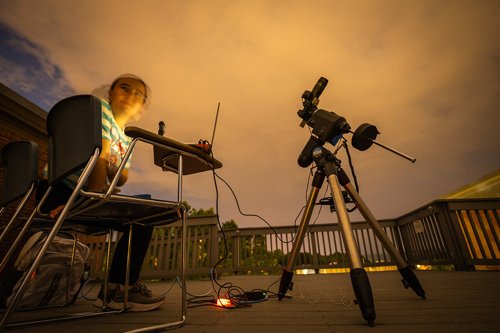 Nightime image of Rosa Newshare photographing the sky
