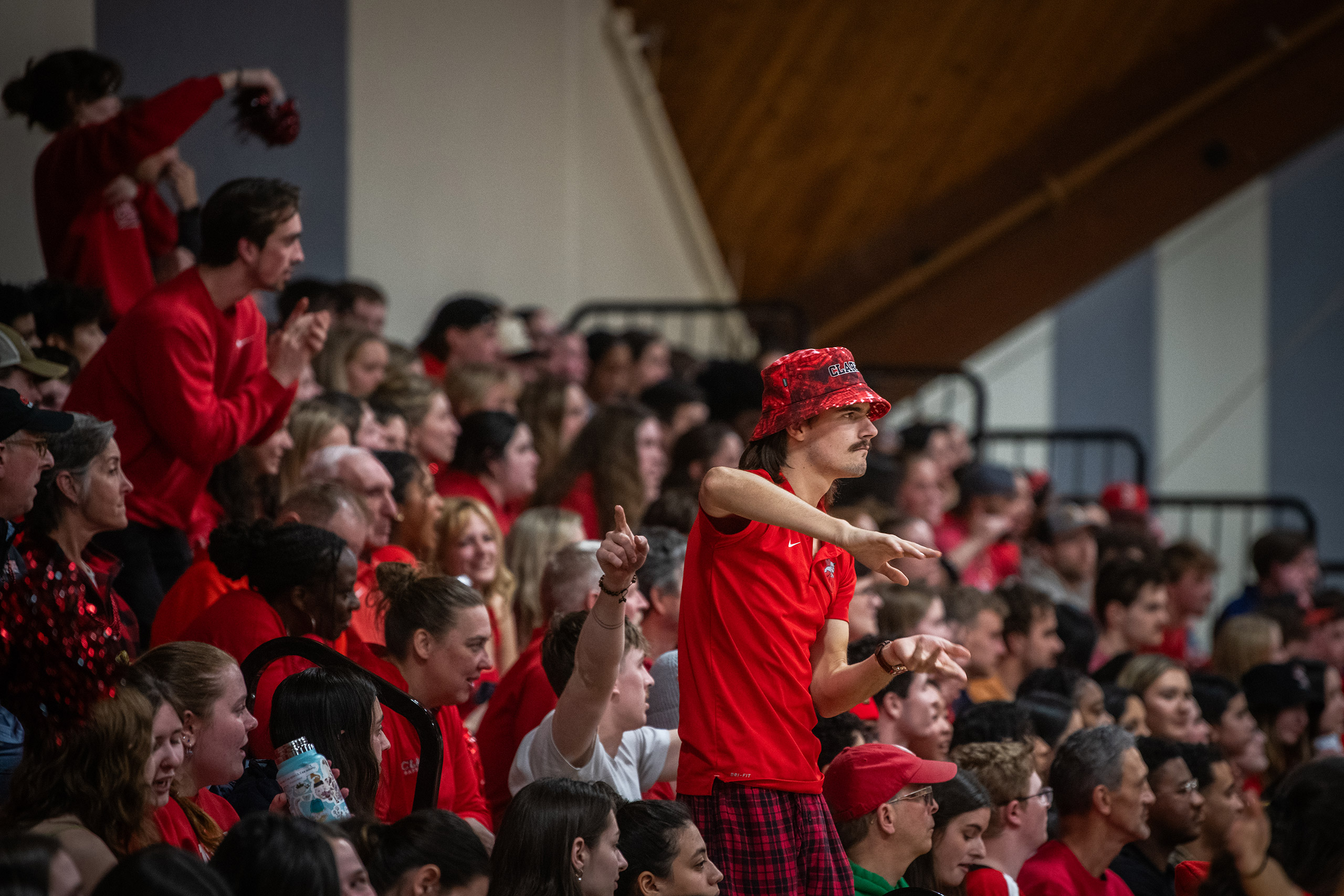 A crowd of students cheering during a mens basketball semi-finals game