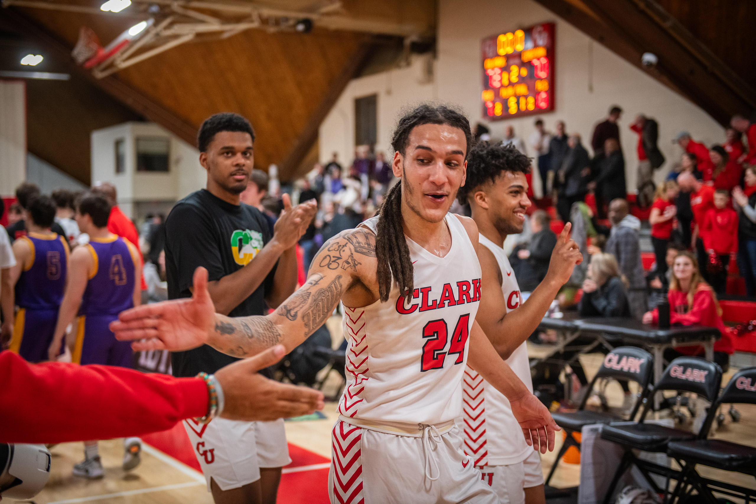 A player reaches out for a high-five during a men's basketball semifinals game