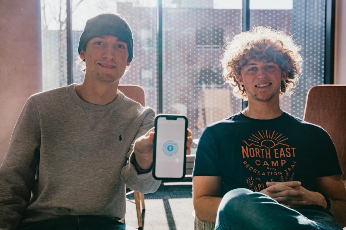 two students holding iPhone