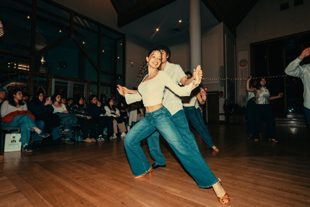 salsa dancers perform in hall