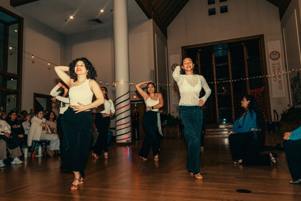salsa dancers perform in hall
