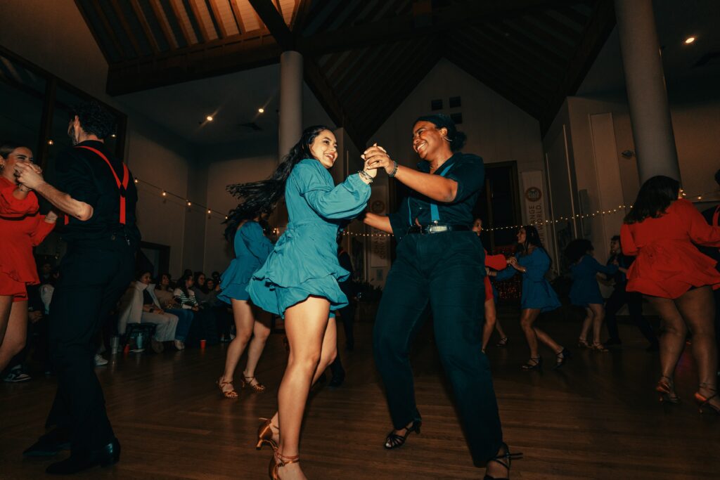 salsa dancers perform in hall