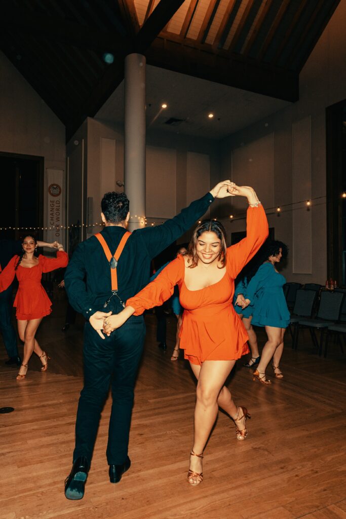 salsa dancers perform in hall