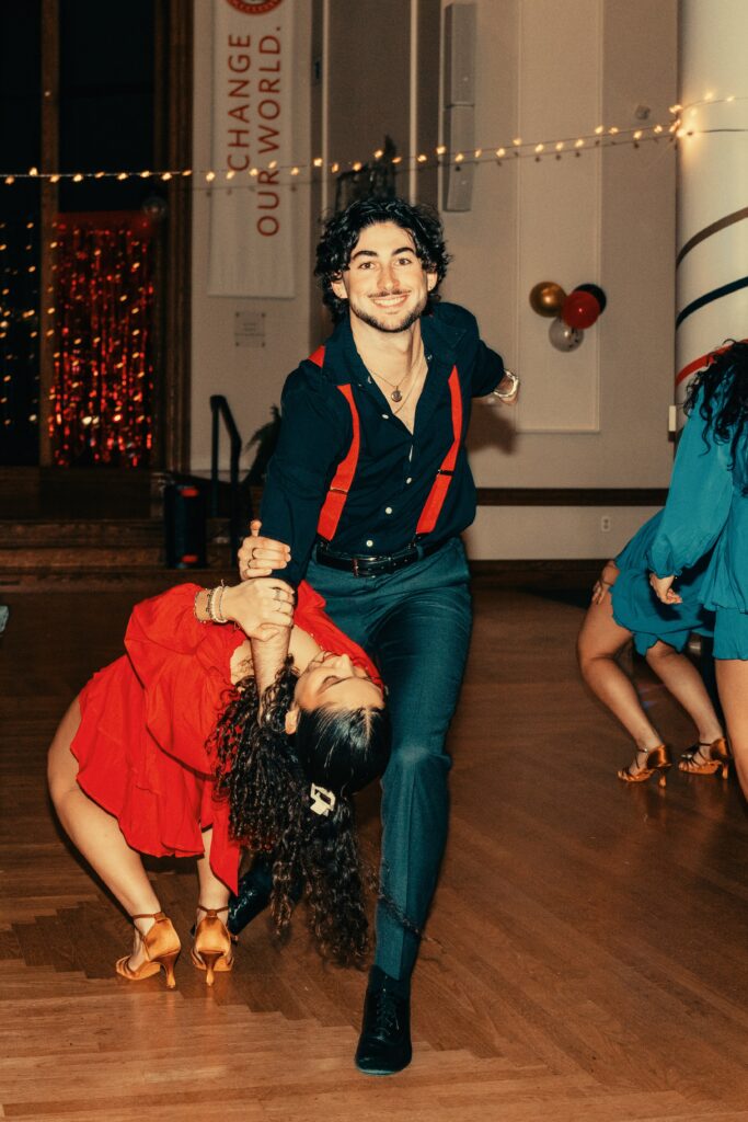 salsa dancers perform in hall