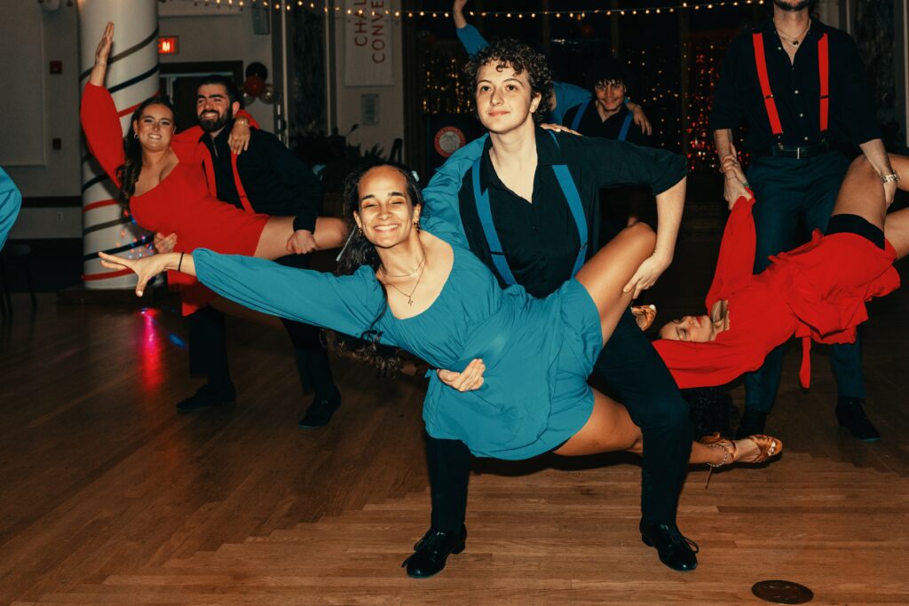 salsa dancers perform in hall