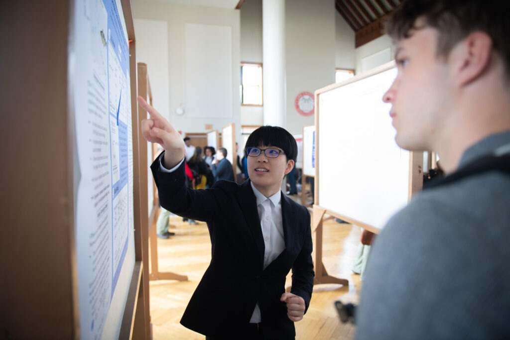 student presents poster