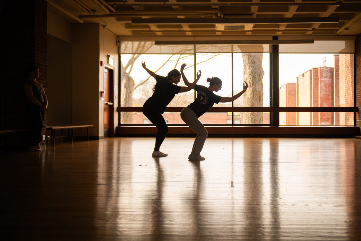 dancers in front of window