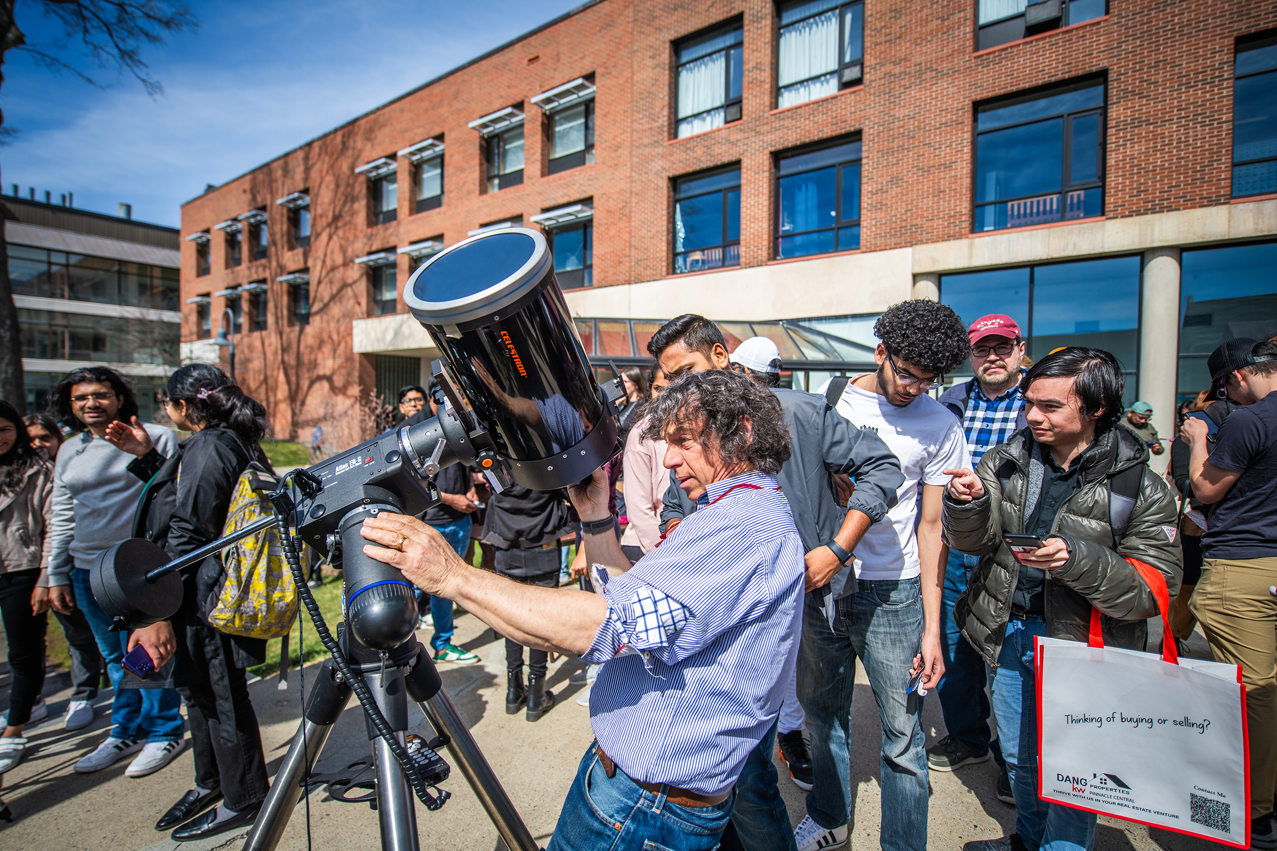 Professor Charles Agosta readies the solar telescope before the eclipse.