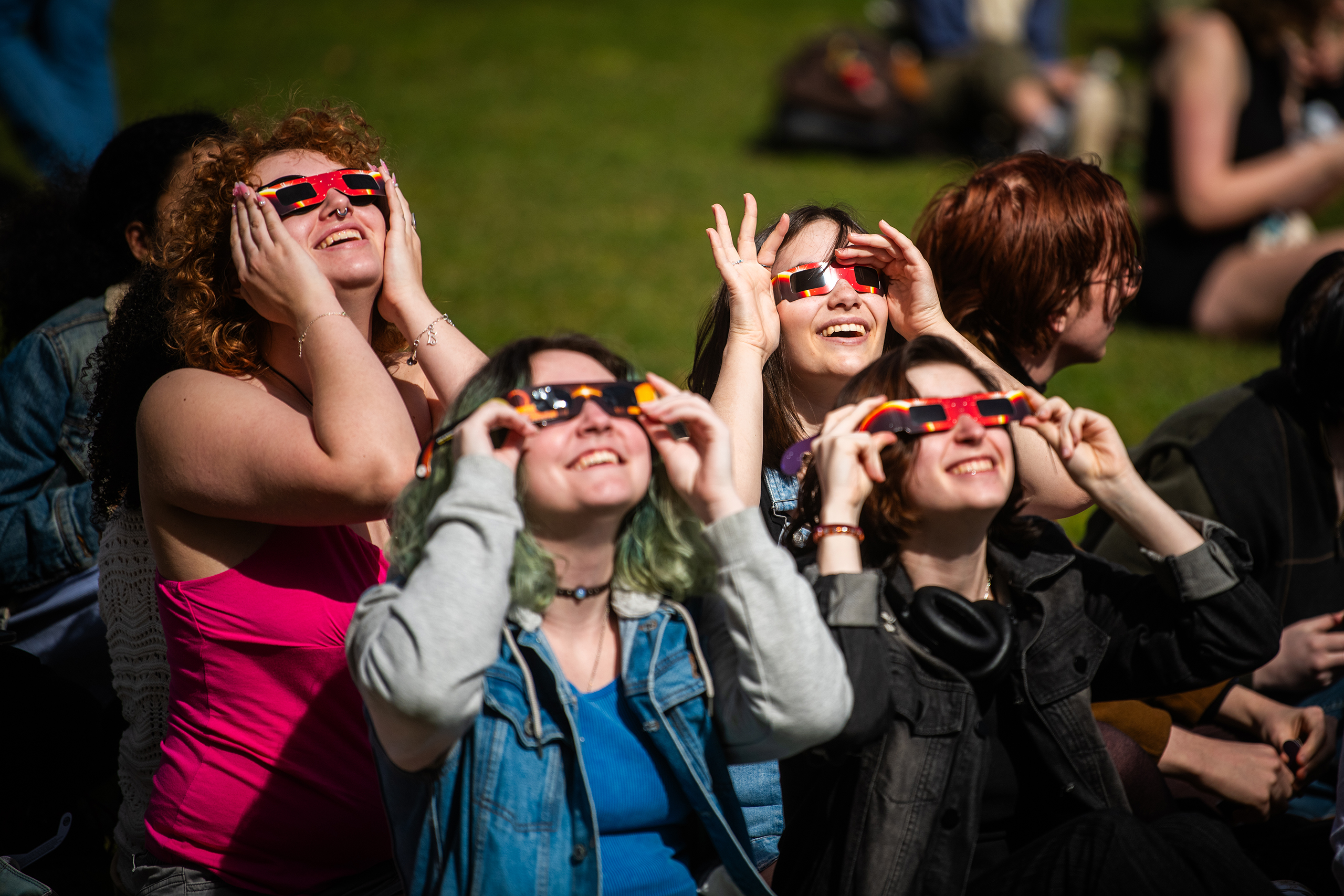 Students watch the partial solar eclipse on April 8, 2024, on the Clark University campus
