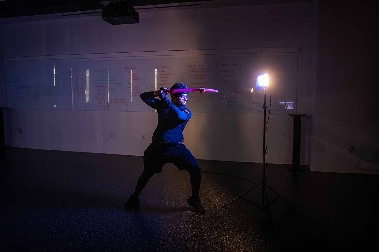 A student blocking movements for a game in a motion studio, Clark University