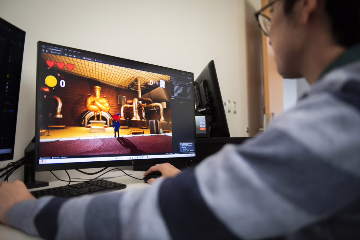person makes video game on computer
