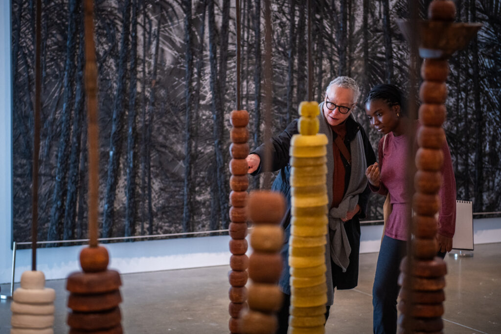 professor and student look at art in museum