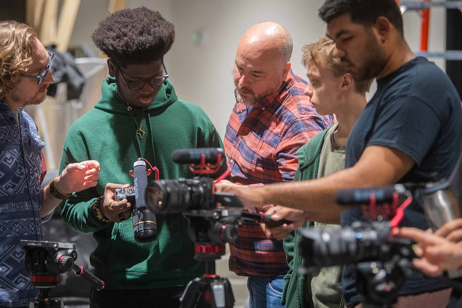 Students learning about the equipment in a digital filmmaking class