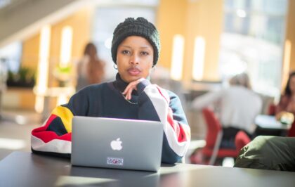 student sitting with laptop