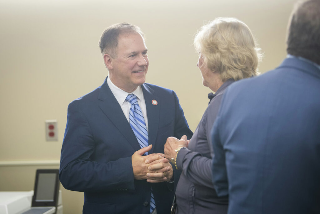 President Fithian talks to an attendee at the ribbon cutting
