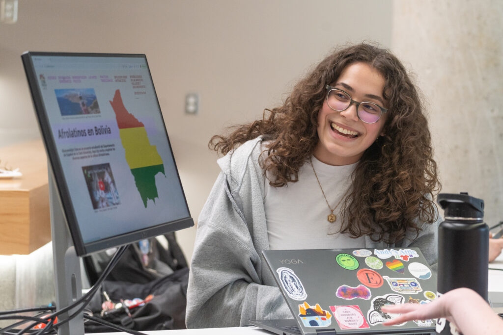 student shows project on computer screen