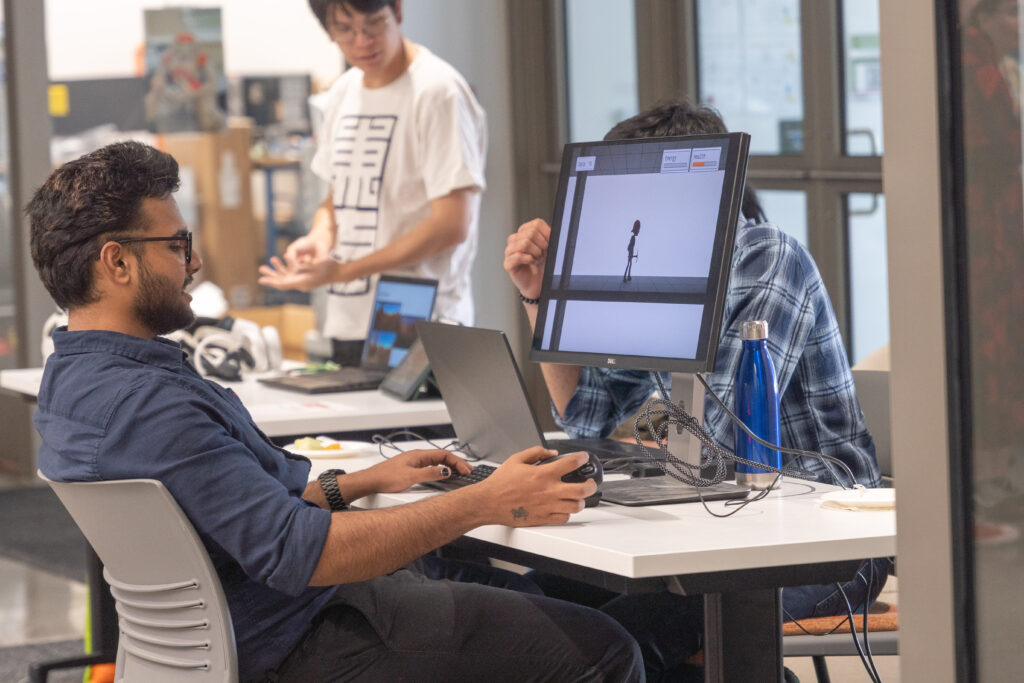 students demo video games during showcase