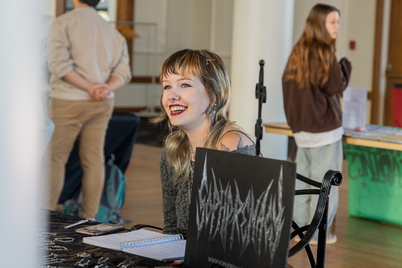 student sitting at table with jewelry